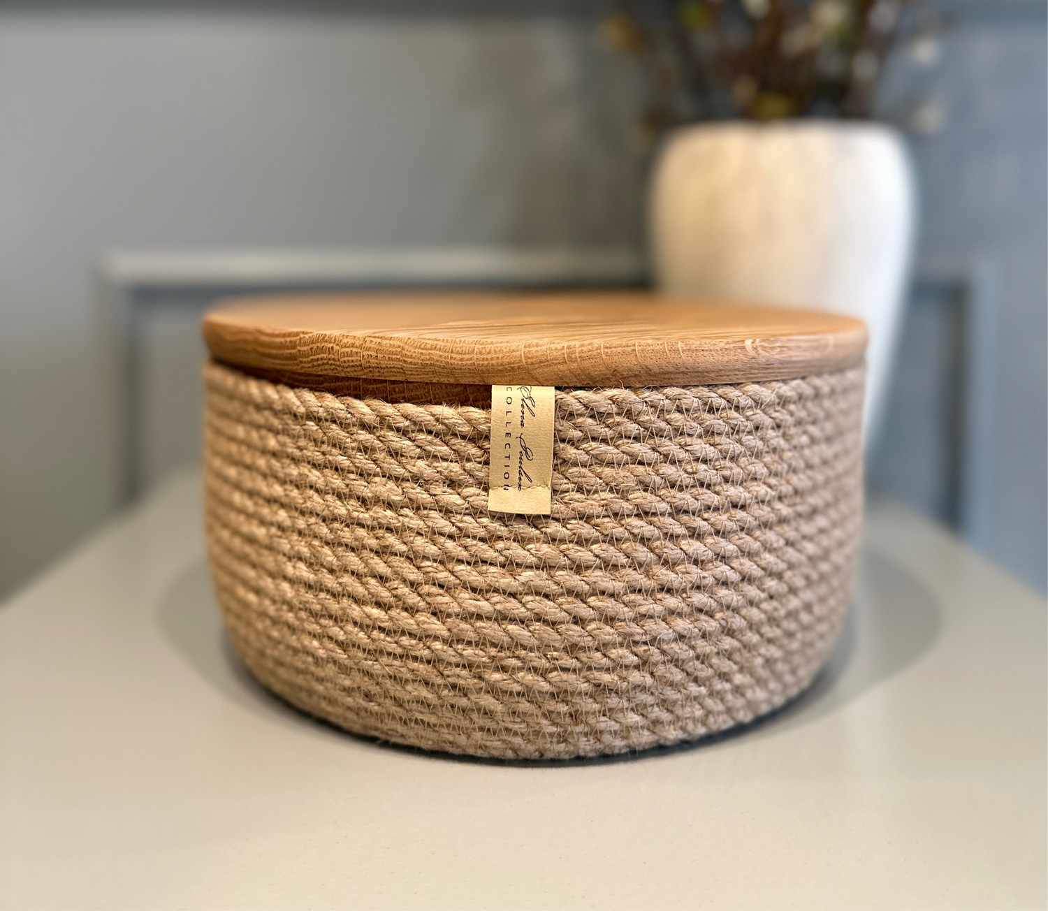 Håndlavet kurv i naturmaterialer – jute og massiv eg i en elegant kombination.