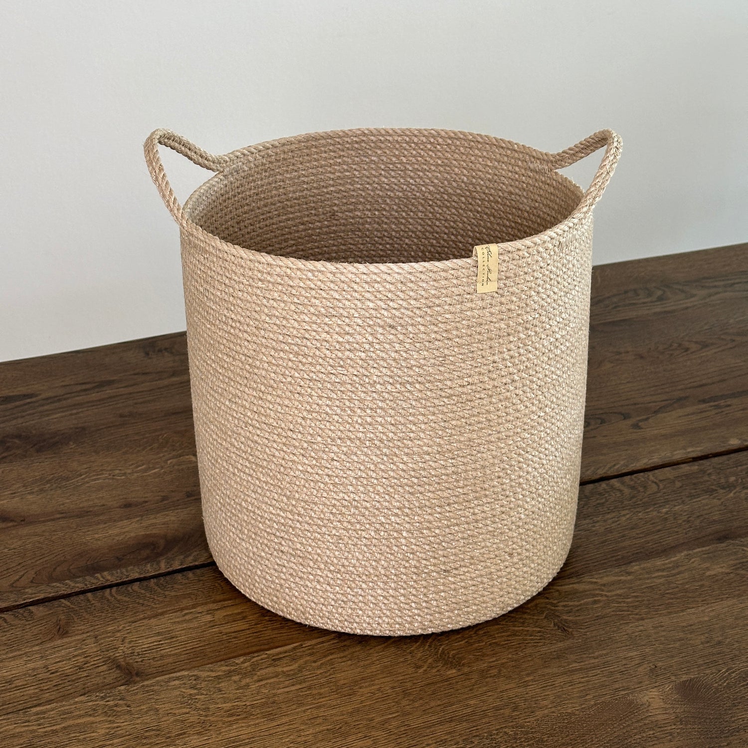 Stor håndlavet kurv i jute med praktiske håndtag, bæredygtig og holdbar.