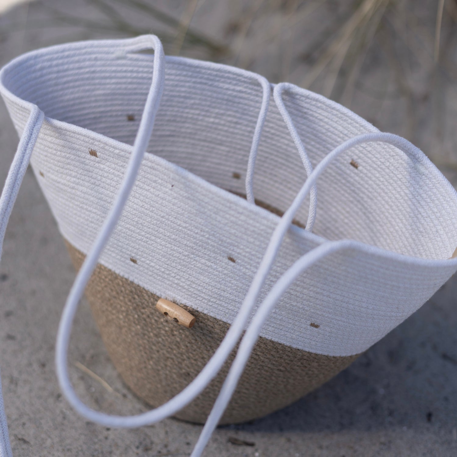 Håndlavet taske i medium størrelse med lange hanke og trælukning. Et holdbart tilbehør skabt med sans for detaljer.
